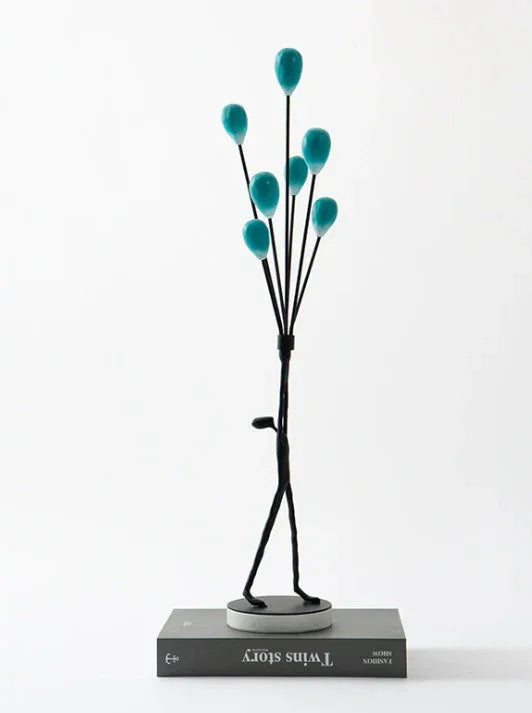 MAN HOLDING BALLOONS IN JOY